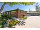 A well-kept brick home with a detached two car garage and a beautifully landscaped front yard at 4530 S Inca St, Englewood, CO 80110