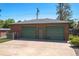 Large two-car garage exterior featuring brick siding, green doors, and concrete driveway at 4530 S Inca St, Englewood, CO 80110
