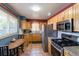 Kitchen with stainless steel appliances, stone countertops, and maple cabinets at 4530 S Inca St, Englewood, CO 80110