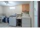 Laundry room with washer, dryer, cabinet space, and utility sink at 4530 S Inca St, Englewood, CO 80110
