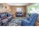 Spacious living room featuring two leather sofas, an accent rug, and natural light at 4530 S Inca St, Englewood, CO 80110
