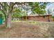 Expansive backyard features a wooden deck, mature tree, and ample space for outdoor activities at 363 Lima St, Aurora, CO 80010