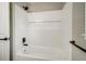 Bathroom featuring a bathtub and shower combination with white subway tile and modern fixtures at 363 Lima St, Aurora, CO 80010