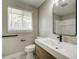 Bathroom with modern vanity, sleek mirror, and window providing natural light at 363 Lima St, Aurora, CO 80010