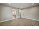 Bedroom view leading to a ensuite bathroom and an open doorway, showcasing hardwood flooring and neutral decor at 363 Lima St, Aurora, CO 80010