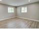 Bright bedroom with hardwood floors, neutral walls, base trim, and natural light from the dual windows at 363 Lima St, Aurora, CO 80010