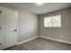 Bedroom showcasing wood-look floors, a window with blinds, and a white door with black hardware at 363 Lima St, Aurora, CO 80010