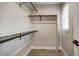 Walk-in closet featuring white walls, dark hanging bars, shelving, and hardwood floors at 363 Lima St, Aurora, CO 80010