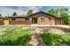 Ranch-style home featuring a manicured lawn, brick exterior, and an attached garage at 363 Lima St, Aurora, CO 80010
