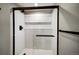 Modern shower featuring white subway tile, sleek black hardware, and built-in shelving at 363 Lima St, Aurora, CO 80010