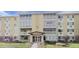 A light yellow apartment complex with well-maintained landscaping and ample natural light at 695 S Alton Way # 6B, Denver, CO 80247