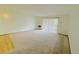 Spacious living room featuring neutral carpet and a sliding door for plenty of natural light at 695 S Alton Way # 6B, Denver, CO 80247