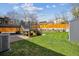 Well-maintained backyard featuring a deck, lush lawn, and a privacy fence at 9379 W Burgundy Ave, Littleton, CO 80123
