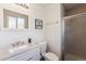 Well-lit bathroom featuring a vanity with solid surface countertop, toilet, and a shower stall at 9379 W Burgundy Ave, Littleton, CO 80123