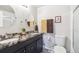 Clean bathroom with double sink vanity, decorative mirror, and neutral color scheme at 9379 W Burgundy Ave, Littleton, CO 80123