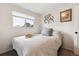 Serene bedroom with a cozy bed, a large window and stylish wall decor at 9379 W Burgundy Ave, Littleton, CO 80123
