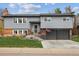 Charming two-story home with gray siding, brick accents, and a well-manicured front lawn at 9379 W Burgundy Ave, Littleton, CO 80123