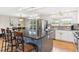 Bright kitchen with stainless steel appliances, gray cabinets, and a granite-topped island at 9379 W Burgundy Ave, Littleton, CO 80123