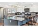 Modern kitchen featuring granite countertops, a gray backsplash, and stainless steel appliances at 9379 W Burgundy Ave, Littleton, CO 80123