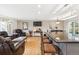 Open-concept living area with hardwood floors, recessed lighting, and a kitchen island at 9379 W Burgundy Ave, Littleton, CO 80123