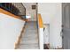 Welcoming staircase with carpeted steps and wooden handrails, leading to the upper level at 9379 W Burgundy Ave, Littleton, CO 80123