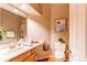 Clean bathroom with wood vanity, updated fixtures and art at 8855 Green Meadows Dr, Highlands Ranch, CO 80126