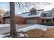 Two-story townhome with attached garage and snow-covered lawn at 8855 Green Meadows Dr, Highlands Ranch, CO 80126