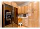 Spacious kitchen with wood cabinets and black appliances at 8855 Green Meadows Dr, Highlands Ranch, CO 80126