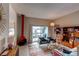 Living room with red fireplace, sliding glass door to deck and built-in shelving at 8855 Green Meadows Dr, Highlands Ranch, CO 80126