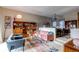 Open living area with pink sofa and built-in shelving at 8855 Green Meadows Dr, Highlands Ranch, CO 80126