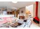 Bright living room features a pink couch, wood accents, and a modern fireplace at 8855 Green Meadows Dr, Highlands Ranch, CO 80126