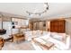 Bright and airy living room with white sectional sofa and kitchen at 8855 Green Meadows Dr, Highlands Ranch, CO 80126