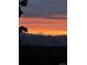 Orange and purple sunset over distant mountains at 8855 Green Meadows Dr, Highlands Ranch, CO 80126
