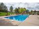 Inviting community pool with lounge chairs and a pergola at 8855 Green Meadows Dr, Highlands Ranch, CO 80126