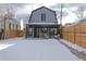 Covered patio and fenced backyard with fresh snow at 2031 W 37Th Ave, Denver, CO 80211