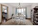 Bright dining room featuring a farmhouse table, large window, and elegant china cabinet at 1331 Alpine St, Longmont, CO 80504