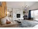 Cozy living room with a stone fireplace, wood accent wall, and stylish furnishings at 1331 Alpine St, Longmont, CO 80504