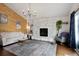 Comfortable living room with a stone fireplace, hardwood floors, and a vintage rug at 1331 Alpine St, Longmont, CO 80504