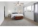 Bright bedroom featuring carpet, large window, ceiling fan, and white walls at 1331 Alpine St, Longmont, CO 80504