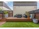 A cozy backyard deck with stylish outdoor seating and artificial turf, perfect for relaxing at 2824 W Parkside Pl, Denver, CO 80221