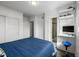 A comfortable bedroom with a work-from-home setup and en-suite bathroom featuring modern design at 2824 W Parkside Pl, Denver, CO 80221