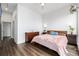 Bright bedroom with wood floors, ceiling fan, and comfortable bed; plants add a cozy touch at 2824 W Parkside Pl, Denver, CO 80221