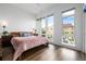 Bright bedroom featuring large windows, wood floors, and a modern design at 2824 W Parkside Pl, Denver, CO 80221