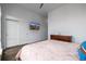 Bedroom featuring ample storage, a media screen, and comfortable bed for relaxing at 2824 W Parkside Pl, Denver, CO 80221