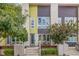 Modern townhome showcasing vibrant architecture, lush landscaping, and inviting outdoor seating area at 2824 W Parkside Pl, Denver, CO 80221