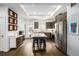 Contemporary kitchen featuring a center island, stainless steel appliances, modern cabinets, and wood floors at 2824 W Parkside Pl, Denver, CO 80221