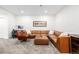 Spacious living room with a large sectional, area rug, and a designated work area at 2824 W Parkside Pl, Denver, CO 80221