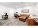 A spacious living room with a large sectional sofa, desk, and plush carpeting at 2824 W Parkside Pl, Denver, CO 80221