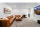 Large living room featuring a brown leather sofa, and carpeted floors at 2824 W Parkside Pl, Denver, CO 80221