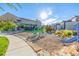 A community playground with modern play structures and landscaping, set against a backdrop of residential buildings at 2824 W Parkside Pl, Denver, CO 80221